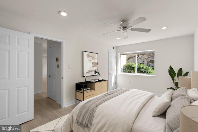 bedroom with ceiling fan and light hardwood / wood-style flooring