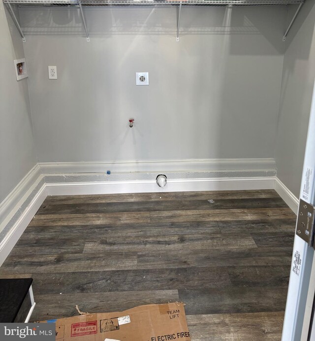 clothes washing area with hookup for an electric dryer, dark hardwood / wood-style floors, and washer hookup