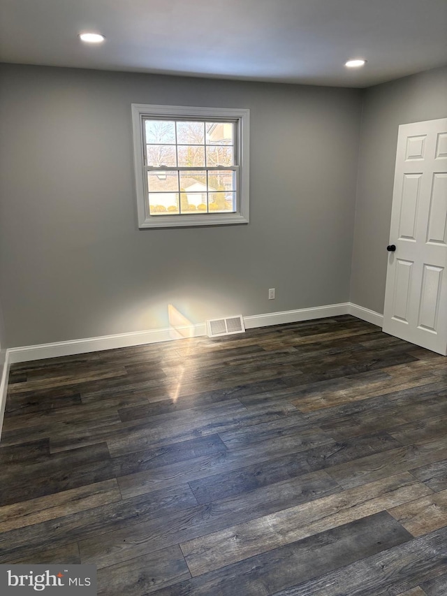 spare room with dark hardwood / wood-style flooring