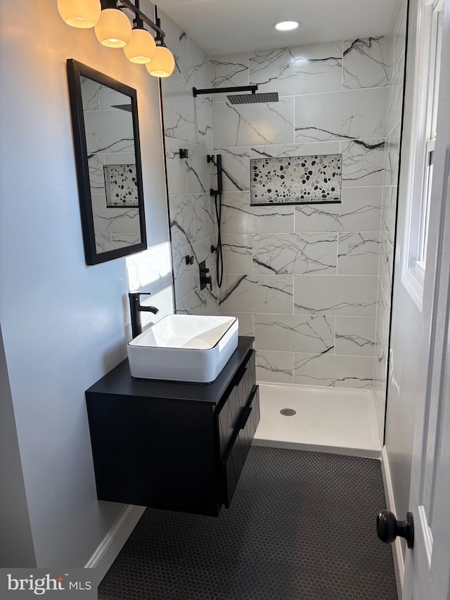 bathroom with vanity and tiled shower