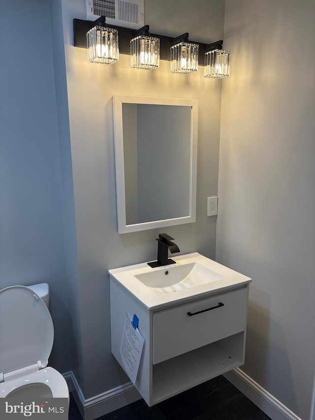 bathroom featuring vanity and toilet