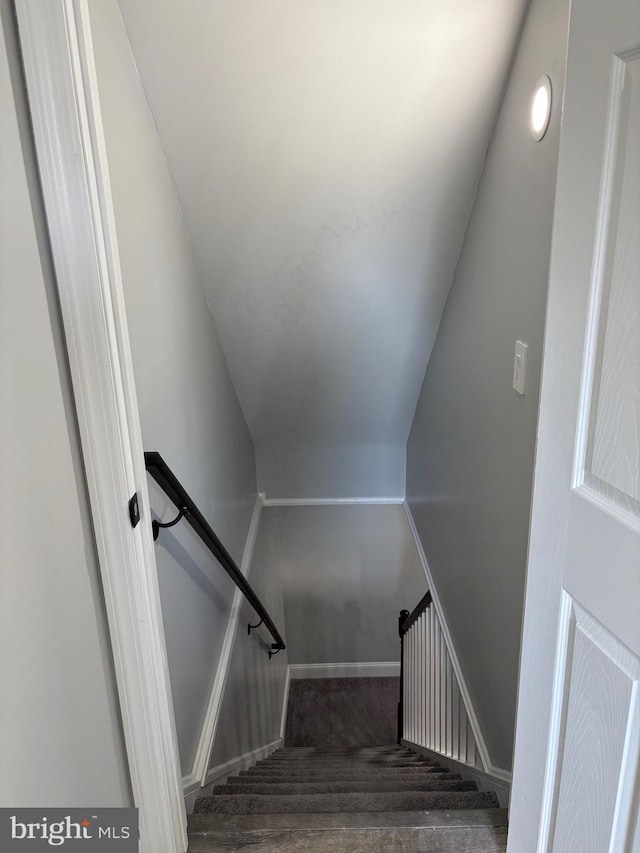 stairs featuring vaulted ceiling