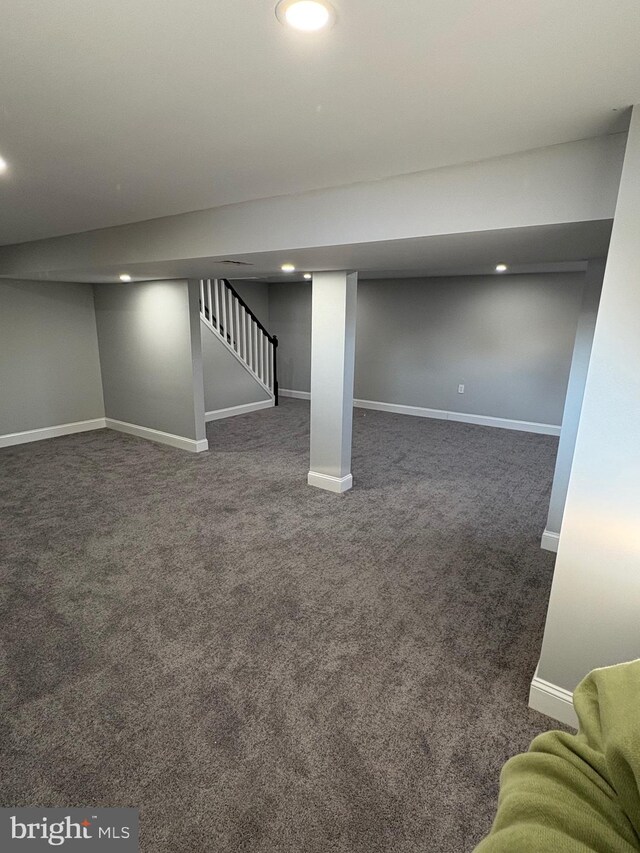 basement with dark colored carpet