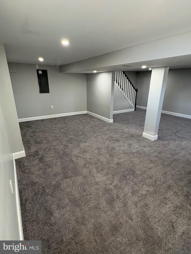 basement with dark colored carpet