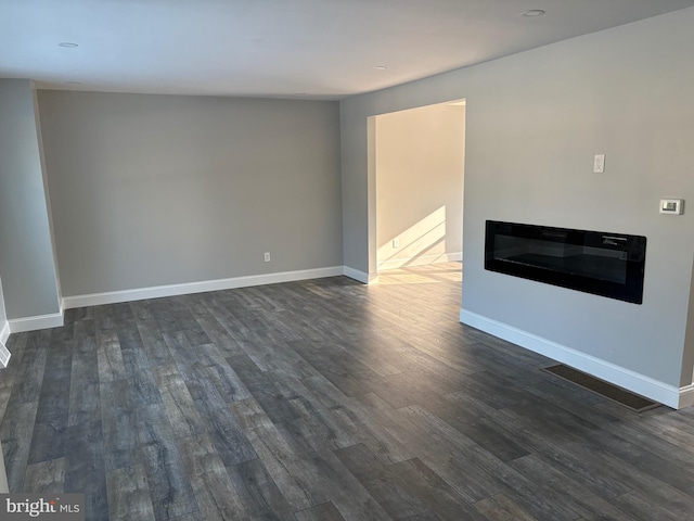 unfurnished living room featuring dark wood-type flooring