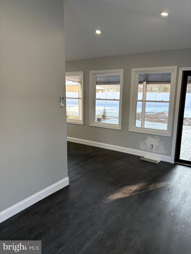 empty room featuring dark wood-type flooring