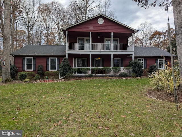 view of front of property featuring a balcony and a front yard