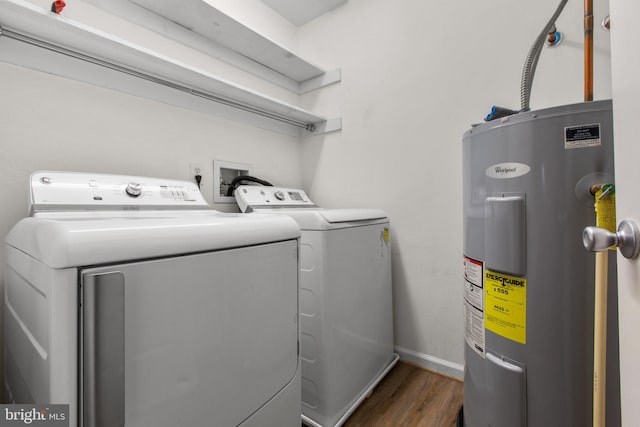 washroom featuring separate washer and dryer, dark wood-type flooring, and water heater