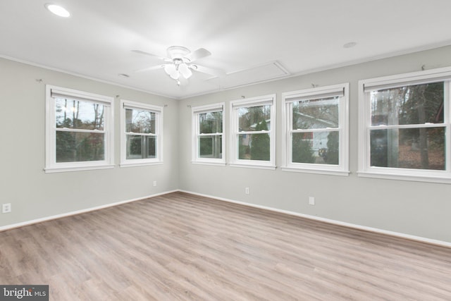 unfurnished room featuring ceiling fan, crown molding, a wealth of natural light, and light hardwood / wood-style flooring