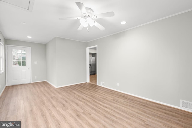 empty room with light wood-type flooring, ceiling fan, and ornamental molding