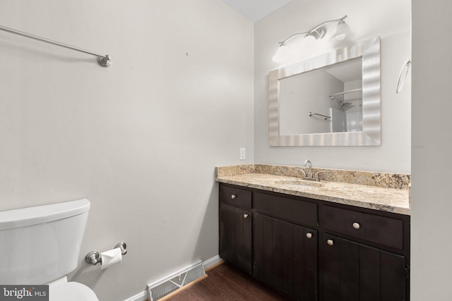 bathroom featuring hardwood / wood-style floors, vanity, and toilet