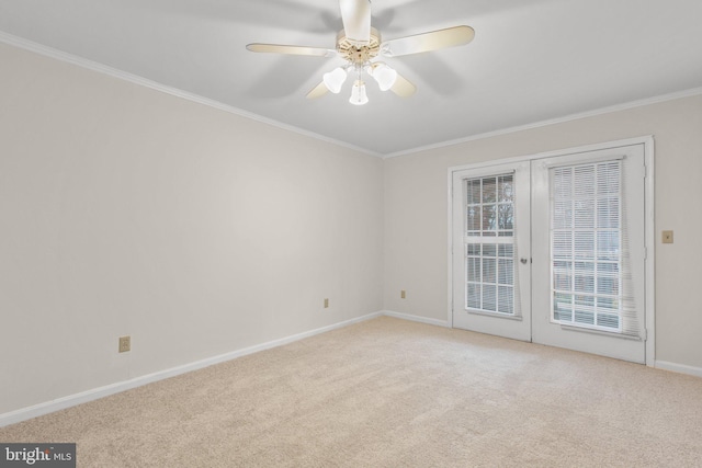 empty room with ceiling fan, ornamental molding, light carpet, and french doors