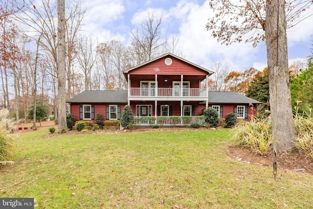 view of front of house featuring a balcony and a front yard