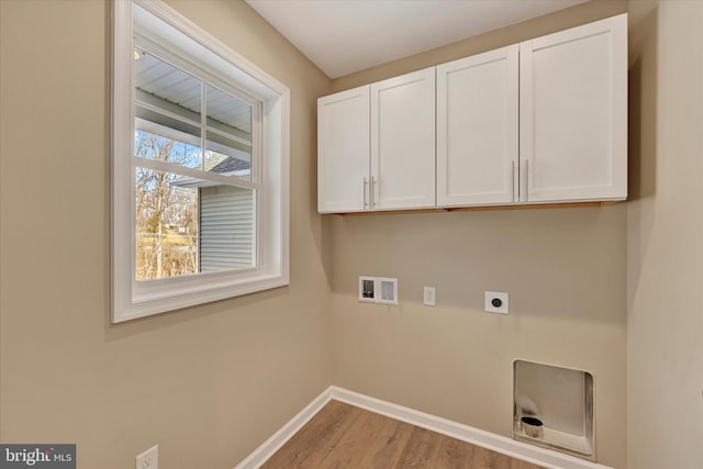 laundry area with cabinets, hookup for a washing machine, hookup for an electric dryer, and light wood-type flooring