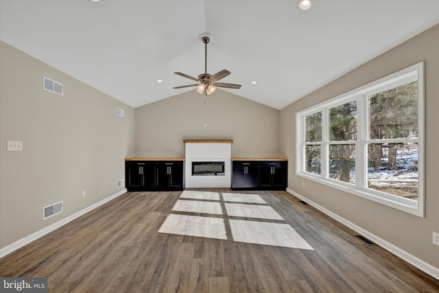 unfurnished living room featuring lofted ceiling, wood-type flooring, and ceiling fan