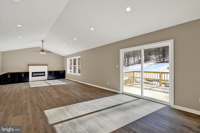 unfurnished living room with dark wood-type flooring, ceiling fan, and lofted ceiling