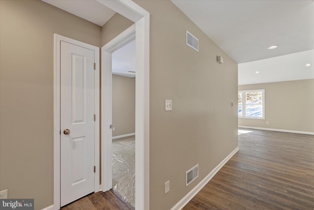 hallway with dark hardwood / wood-style floors