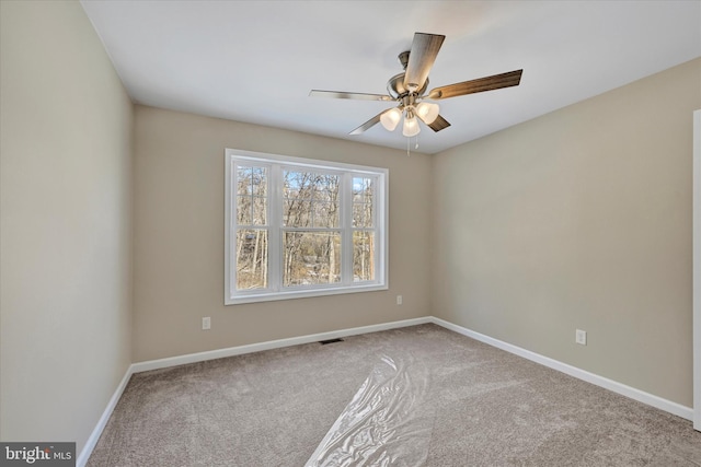 spare room with light colored carpet and ceiling fan