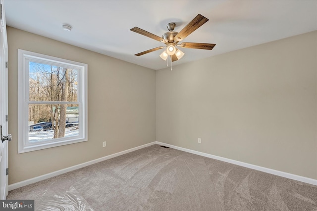 carpeted empty room featuring ceiling fan