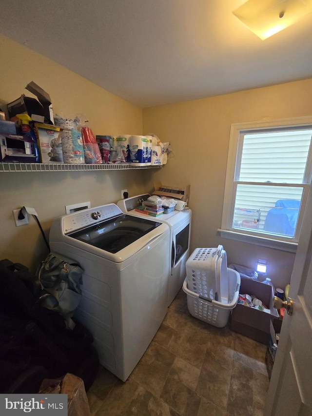 clothes washing area with washing machine and clothes dryer