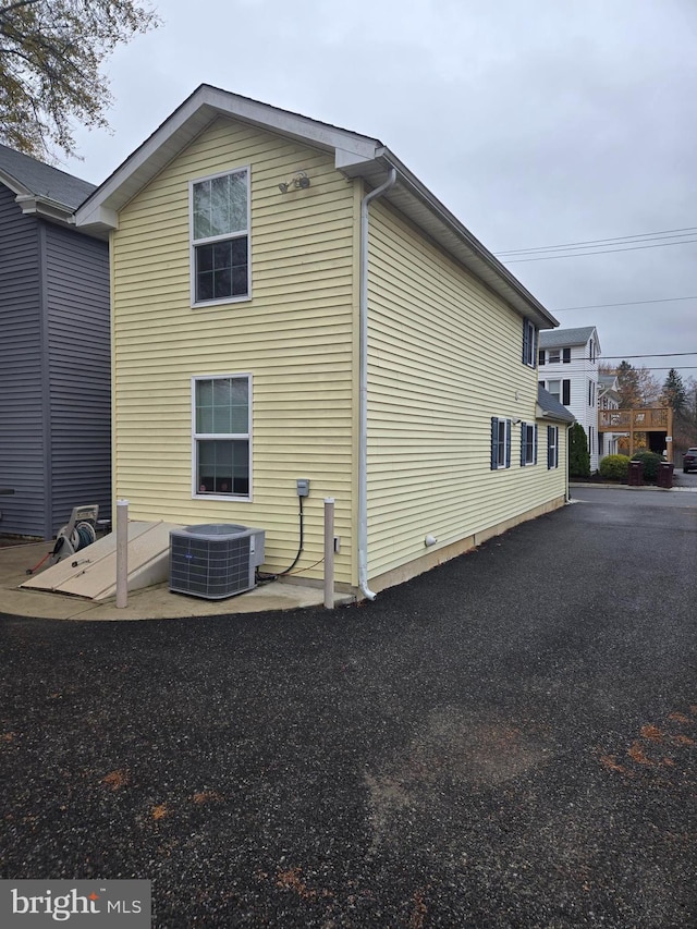 view of side of home featuring central AC unit