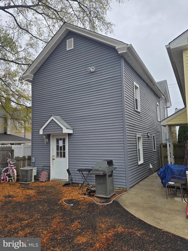 back of house with a patio area and central air condition unit