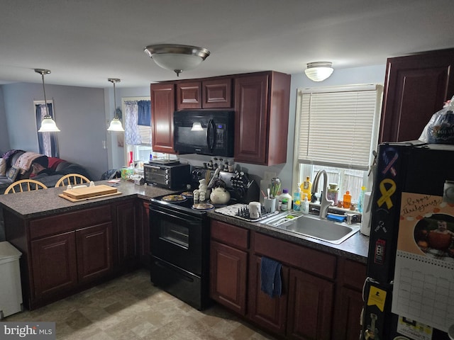 kitchen featuring black appliances, pendant lighting, kitchen peninsula, and sink