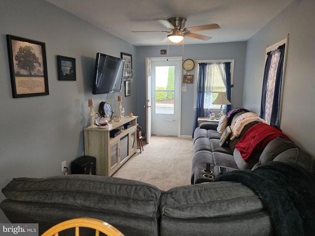 living room featuring light carpet and ceiling fan