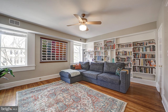 living room with hardwood / wood-style floors, ceiling fan, and plenty of natural light