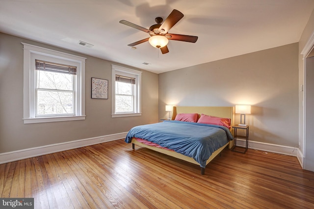 bedroom with hardwood / wood-style flooring and ceiling fan