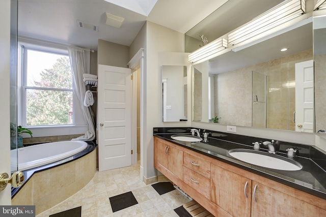 bathroom with vanity, tile patterned floors, and separate shower and tub