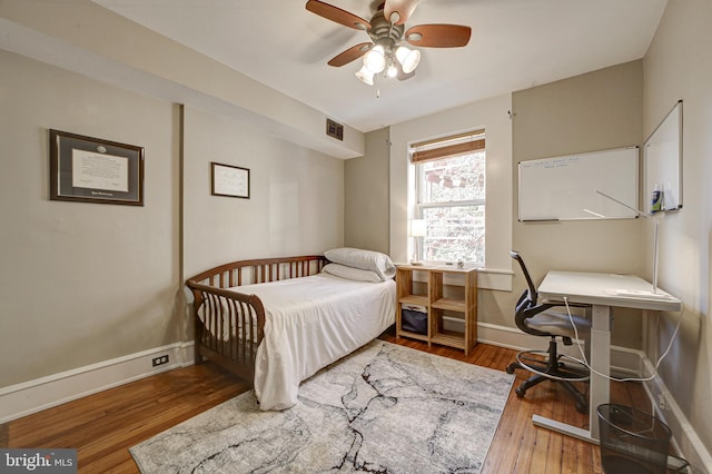 bedroom with wood-type flooring and ceiling fan