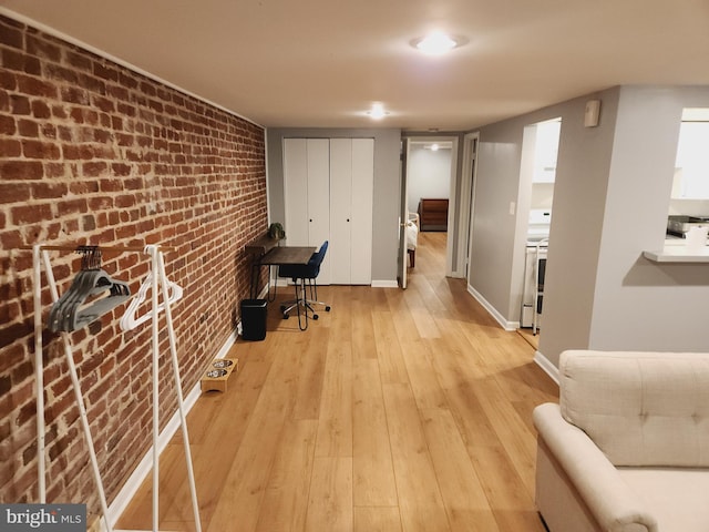 office featuring light hardwood / wood-style floors and brick wall