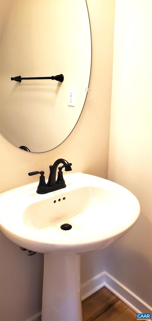 bathroom with hardwood / wood-style floors