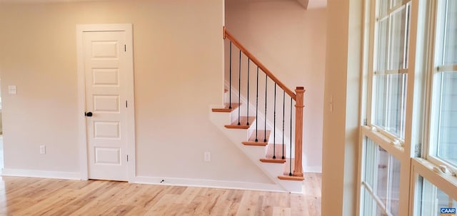 stairs featuring hardwood / wood-style flooring