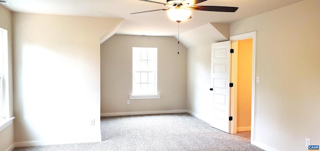 bonus room with vaulted ceiling, light colored carpet, and ceiling fan