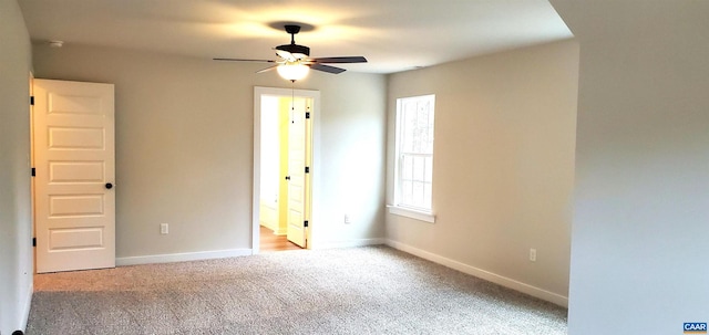 empty room with light colored carpet and ceiling fan