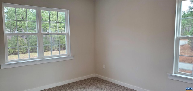 carpeted empty room with plenty of natural light