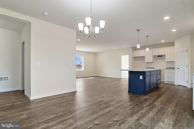 kitchen featuring a kitchen island, pendant lighting, dark hardwood / wood-style floors, and white cabinets