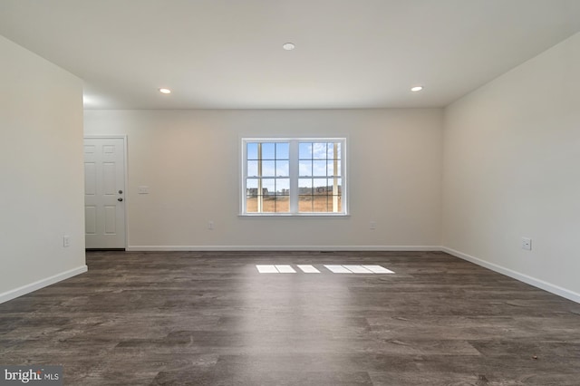 spare room featuring dark hardwood / wood-style flooring