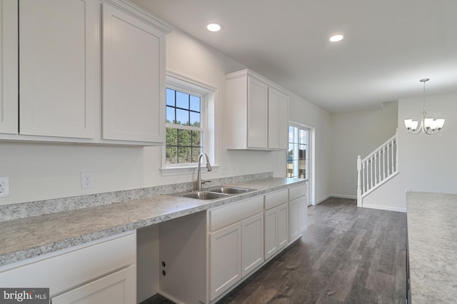 kitchen featuring dark wood-type flooring, a wealth of natural light, and white cabinets