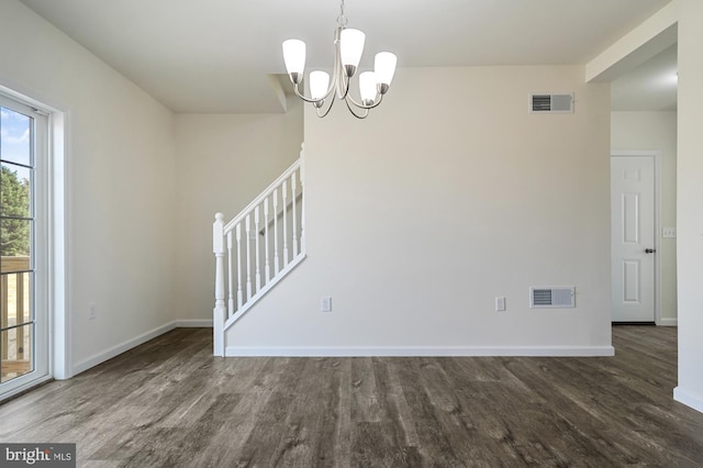 unfurnished dining area featuring dark hardwood / wood-style flooring and a chandelier