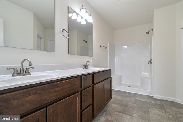 bathroom featuring walk in shower and vanity