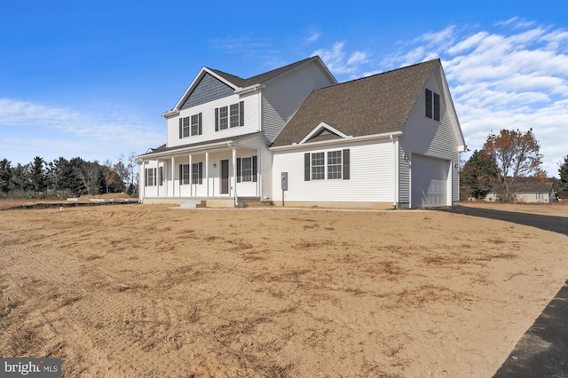 view of front property featuring a porch and a garage