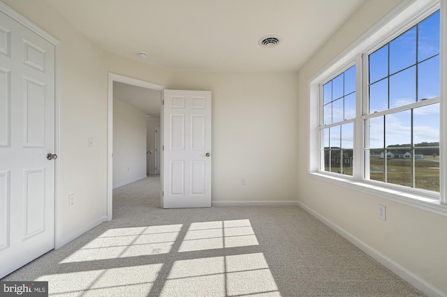 unfurnished bedroom featuring light colored carpet