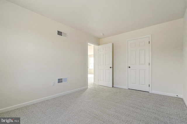 unfurnished bedroom featuring light colored carpet