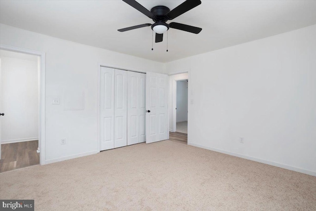 unfurnished bedroom featuring ceiling fan, a closet, and carpet floors