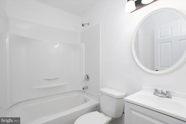 full bathroom featuring washtub / shower combination, vanity, and toilet