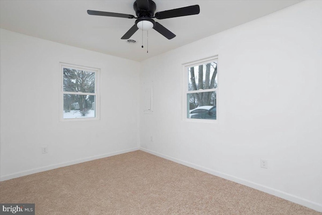 spare room featuring light carpet and ceiling fan