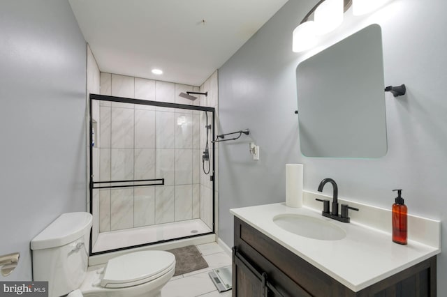 bathroom with vanity, toilet, and a shower with door